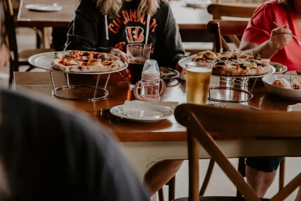 Sitting in Bella Sorella, eating pizza