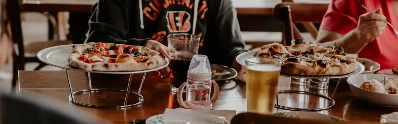 Sitting in Bella Sorella, eating pizza